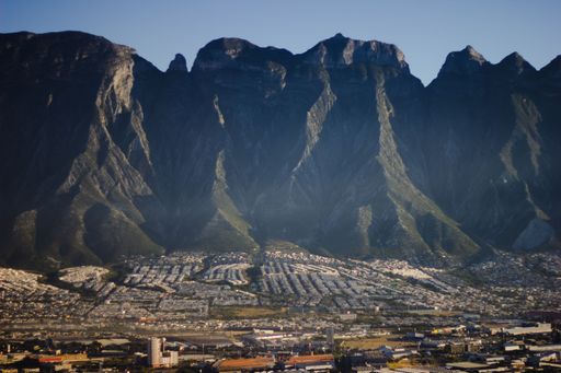 A scenic aerial shot of high rocks in front of a locality in a national park in Mexico