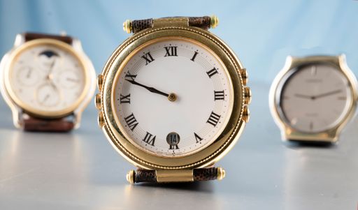 A selective focus on a well-worn classic watch with a vintage clock face with other watches in the background