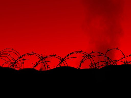A silhouette of prison fence against the red sky