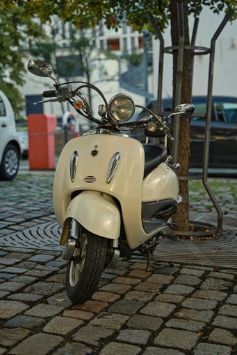 vespa scooter white parked in a city, Germany