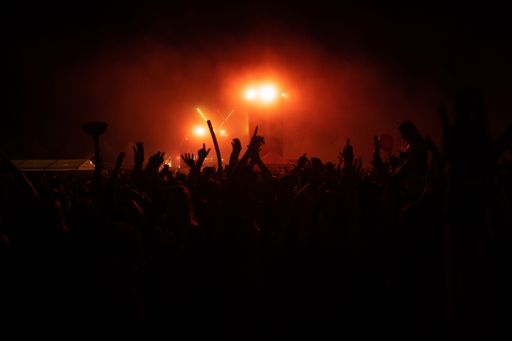 A beautiful shot of hand silhouettes of a crowd at a concert