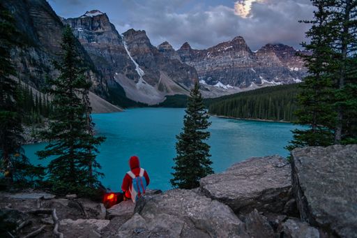 A tourist sitting near the fire in Banff National Park Alberta Canada