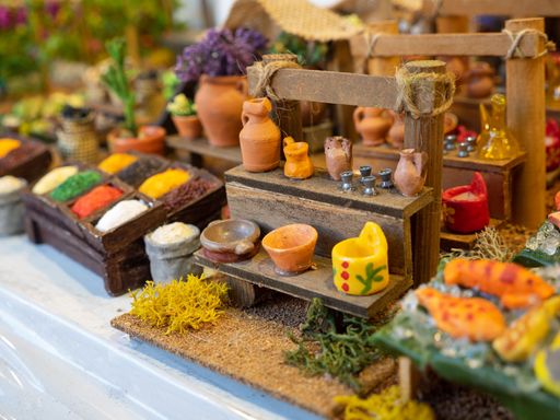 A closeup of traditional souvenirs and toys as small food models of a market