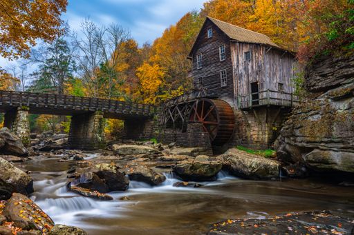 A long exposure of river flowing through Grist Mill at Babcock State Park, West Virginia in autumn