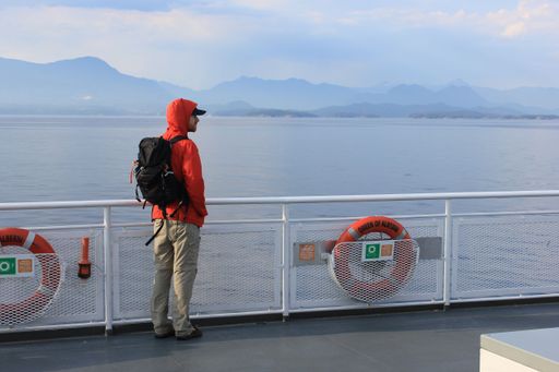 The passenger on the deck of the BC Ferry near Vancouver with mountains and the ocean in the background