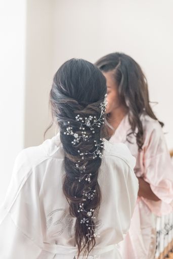 A vertical shot of a bride with a beautiful decorated long hairstyle