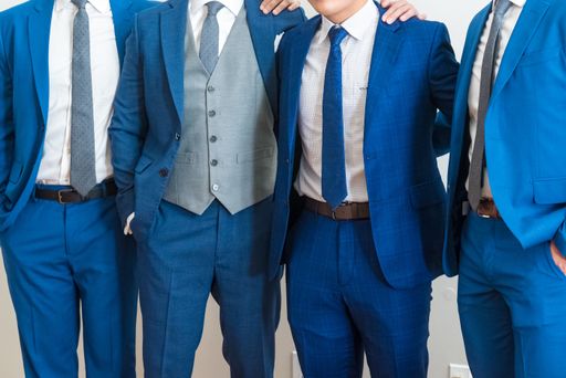 A shallow focus of groomsmen in blue tuxedo