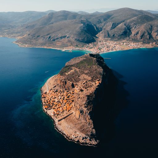 A high angle of the island village buildings with the blue sea below in Monemvasia, Lakonia, Greece