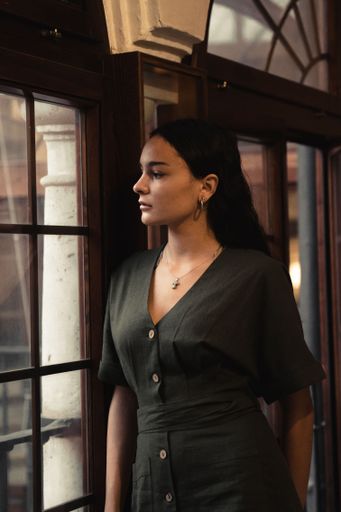 A side view portrait of an attractive brunette looking to the window