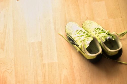 A view of light green sneakers on the floor