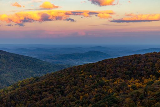 The Shenandoah National Park with forests and hills under a sunset sky during the fall