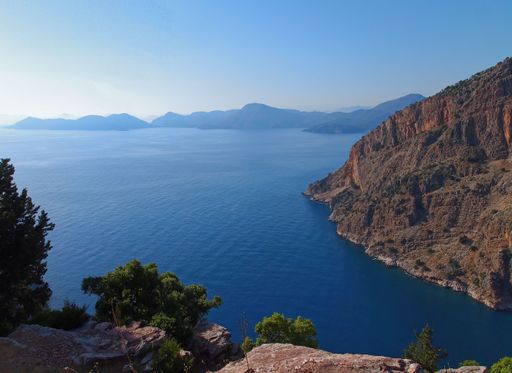 The beautiful blue sea surrounded by big mountains during the daytime in Kabak Turkey