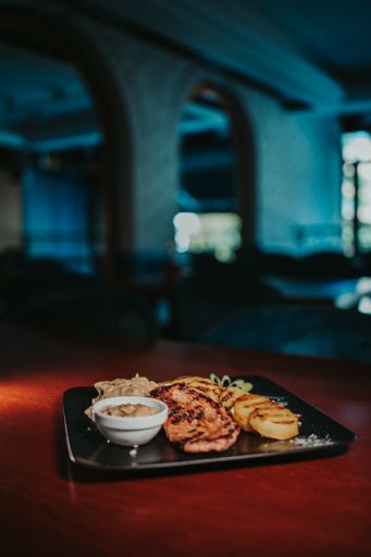 A  closeup shot of a tasty looking dish with fried chicken and french fries
