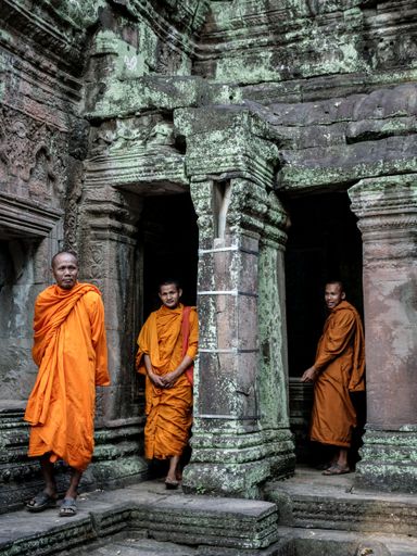 A vertical shot of Buddhist Monks at Ankor Wat Temples