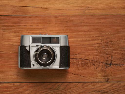 An old camera in wooden background
