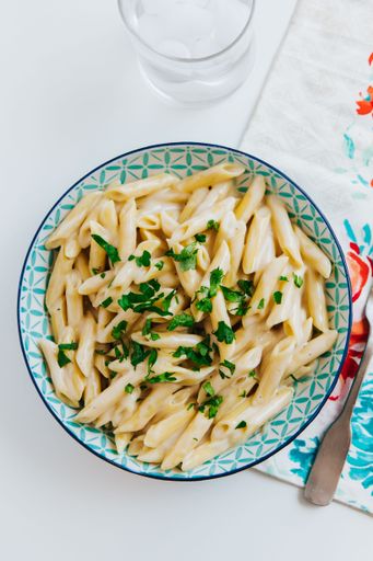 A top view of penne pasta in a bowl