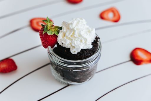 A Chocolate Mug Cake with Strawberries and Whipped Cream