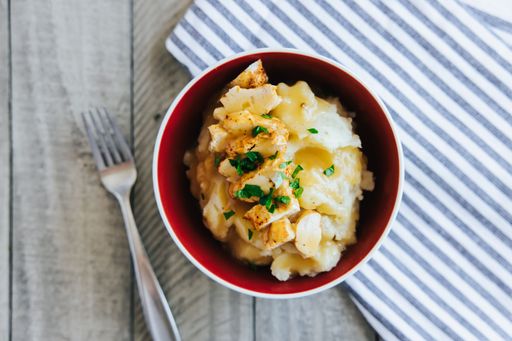 A closeup shot of Grilled Chicken and Mash Potatoes in a small bowl