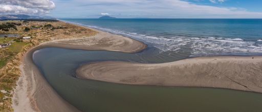 An aerial panorama of Waikawa beach and stream mouth on the Kapiti Coast of New Zealand