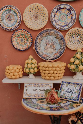 A vertical of beautiful vibrant plates in a wall in the street of Positano, Amalfi, Campania, Italy