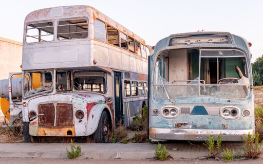 An old abandoned retro bus and a truck