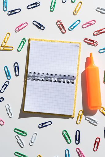 Message Written On Notebook With Colorful And Marker Around. Information Presented On Notepad With Clips All Over. Critical Data Shown On Note.