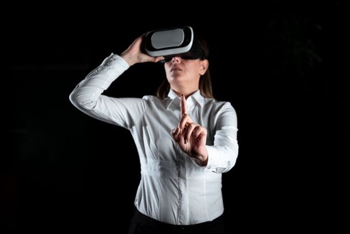 Businesswoman Standing And Gesturing While Learning Skill Through Virtual Reality Simulator. Elegant Woman Presenting Training Techniques.