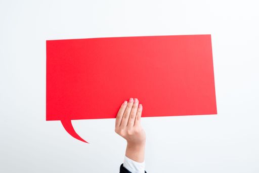 Businesswoman Holding Speech Bubble With Messages With One Hand. Woman Presenting Crutial Information On Dialogue Balloon. Lady Showing On Paper.