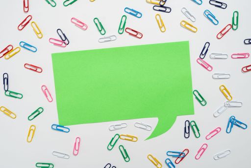 Colorful Paperclips Placed Around Speech Bubble With Information. Colored Clips Arranged All Over Dialogue Balloon With Crutial Announcement.