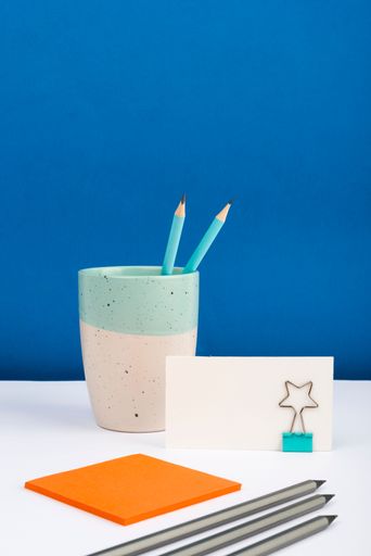 Message Written On Piece Of Paper On Desk With Cup With Pens, Pencils And Notes. Crutial Information Presented On Memo On Table. Critical Data Shown.