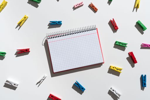 Message Written On Notebook With Colorful Around. Information Presented On Notepad With Colored Clips All Over. Critical Data Shown On Note.