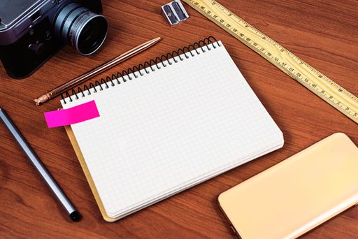 Message Presented On Notebook On Desk With Vintage Camera, Cellphone, Ruler And Sharpener. Crutial Information On Notepad On Table With Phone.