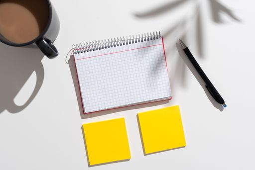 Messages Presented On Notebook And Two Notes On Desk With Coffee And Pen. Crutial Information Written On Notepad And Memos On Table With Cup.
