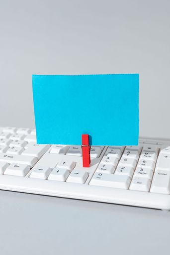 Message Presented On Piece Of Paper Clipped With Clip Above Keyboard. Written On Note. Critical Announcement Displayed On Memo. Ideas Shown.