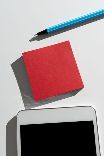 Message Presnted On Sticky Note On Desk With Pen And Mobile Phone. Crutial Information Written On Memo On Table With Cellphone. Critical Data Shown.