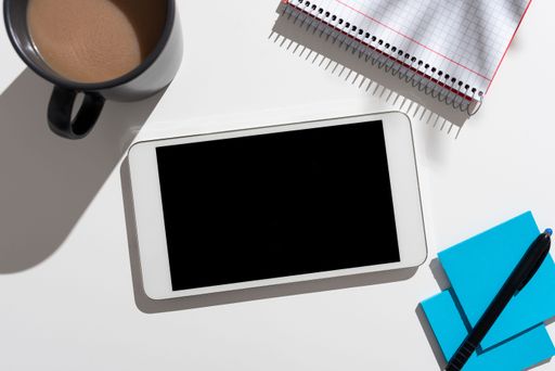 Messages Tablet On Desk With Pen, Notebook, Cup And Notes. Crutial Information On Cellphone Screen On Table With Notepad, Coffee And Memos.