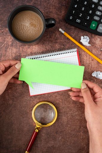 Hands Of Woman Having Thought Bubble Sheet With Copy Space, Coffee Cupen Background. Businesswoman Displaying Branding Ideas And Strategies.
