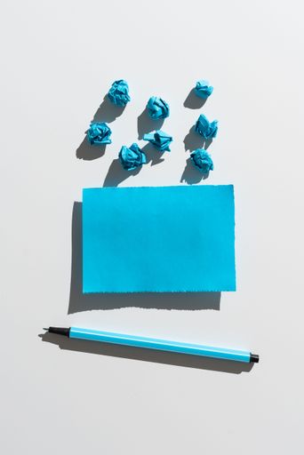 Piece Of Paper With Messages By Paper Wraps And Pen. Crutial Announcement On Paperboard With Crumpled Notes Around. Ideas Presented On Note.