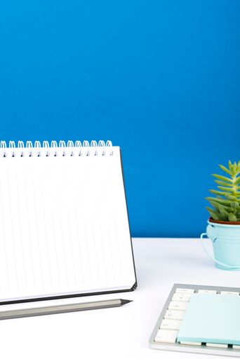 Message Written On Notebook On Desk With Pencil, Keyboard, Note And Flower. Information Presented On Notepad With Plant. Critical Updates Dispayed.