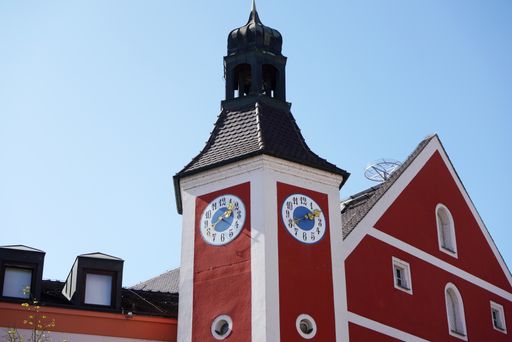 A low angle shot of a church with a clock tower against the blue sky
