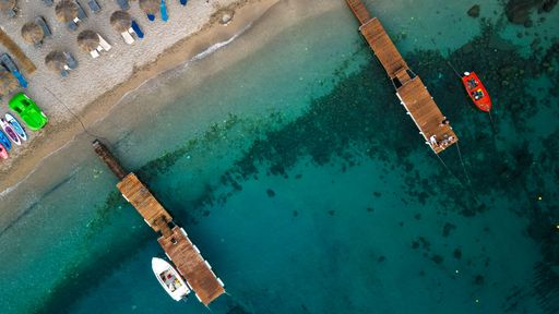 An aerial view of small boats by wooden docks near Corfu island in Greece