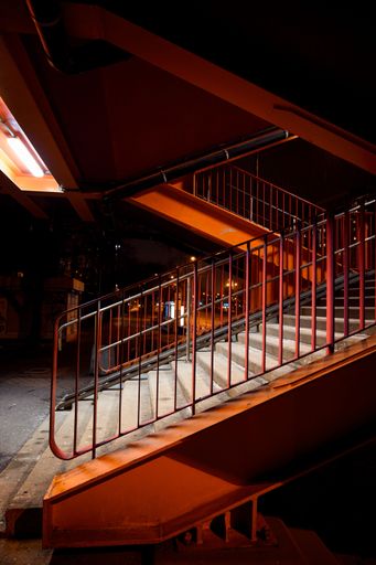 A vertical shot of the stairs of the underground passageway at night