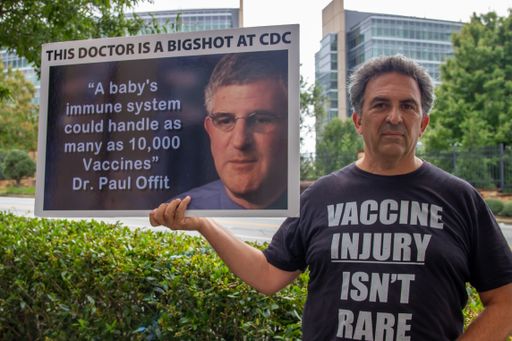 Atlanta, Georgia / United States - September 25 2020: An anti-vaccine protester stands outside of the CDC headquarters in Atlanta, Georgia with signs