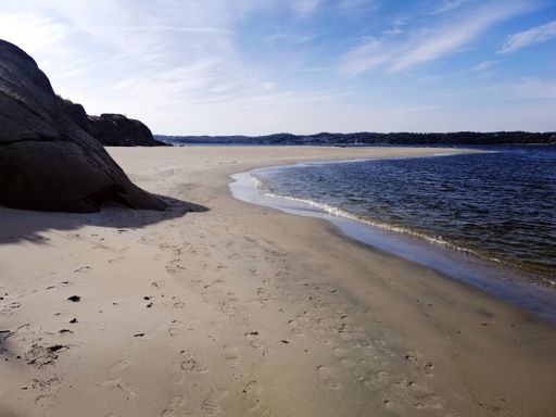 The Hvittensand beach surrounded by the sea under the sunlight in Ostre Halsen, Norway