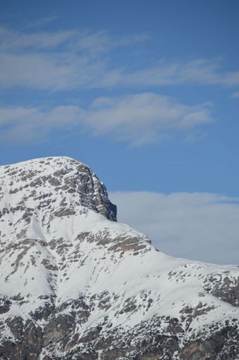 A vertical shot of the peak of a Snowy mountain in Livigno, Italy