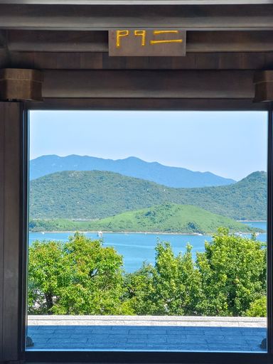 A vertical shot of a landscape seen through a temple entrance
