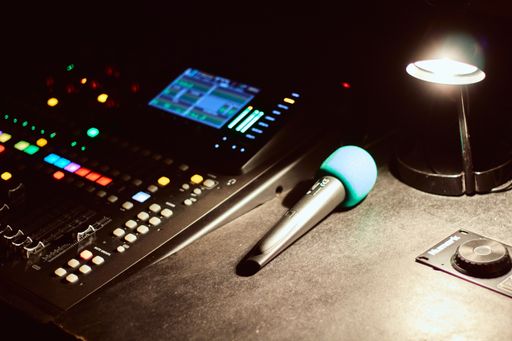 A closeup shot of a microphone near an equalizer