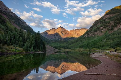 A beautiful landscape of the reflection of Maroon Bells mountain peak on a mirror lake in Colorado