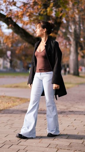 A vertical shot of stylish Southeast Asian young girl walking in the park