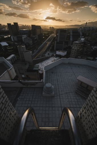 A vertical high angle shot of a cityscape taken from a roof under the sunset sky in Taipei, Taiwan